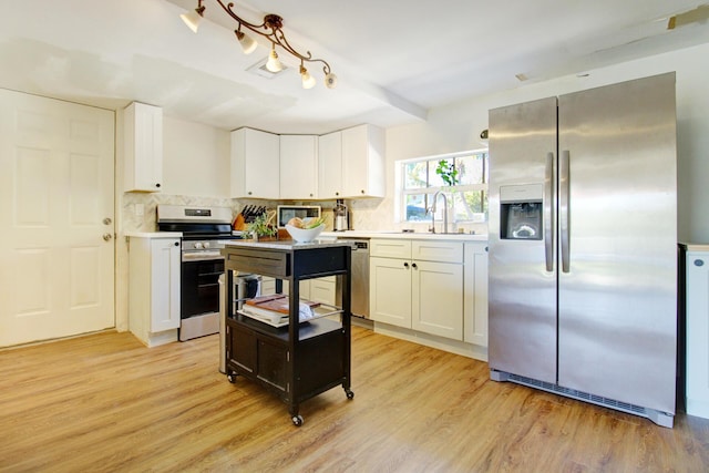 133 Valois Blvd, Key Largo, FL 33037 - kitchen with light countertops, appliances with stainless steel finishes, light wood finished floors, and a sink