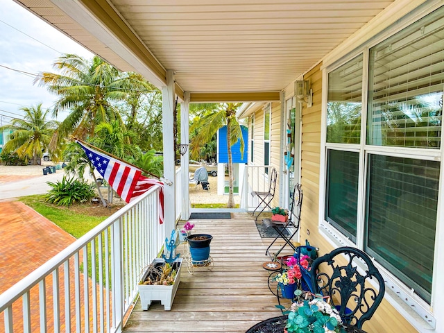 wooden terrace featuring covered porch