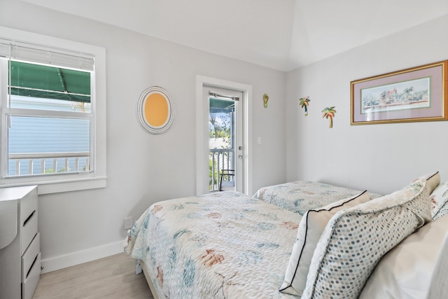 bedroom featuring access to exterior and light hardwood / wood-style floors