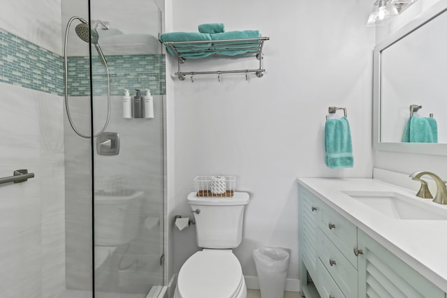 bathroom with vanity, toilet, and an enclosed shower