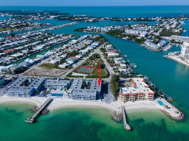 aerial view with a water view and a beach view