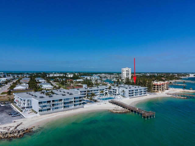 bird's eye view with a water view and a beach view