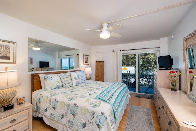 bedroom with access to exterior, light hardwood / wood-style flooring, and ceiling fan