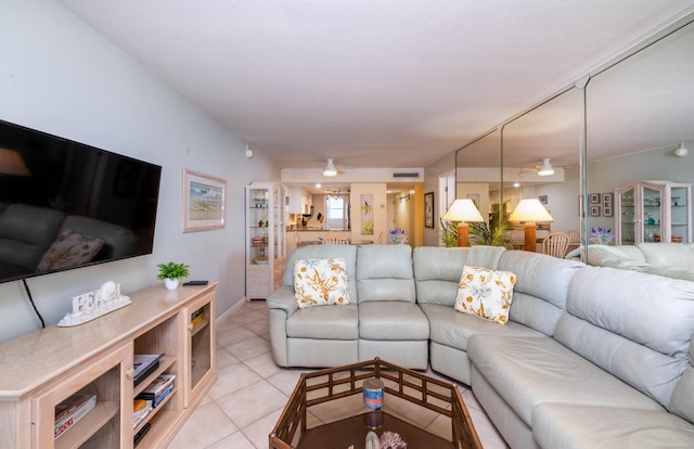 living room featuring ceiling fan and light tile patterned flooring