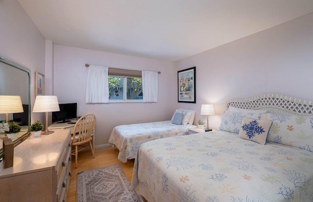 bedroom with hardwood / wood-style floors