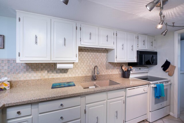 kitchen with tasteful backsplash, sink, white cabinets, and white appliances