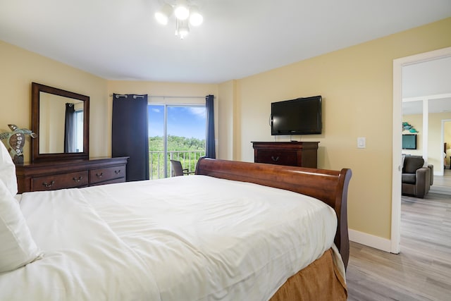 bedroom with access to exterior and light wood-type flooring