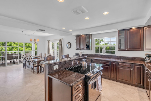 1330 Coury Dr, Key Colony, FL 33051 - kitchen featuring electric stove, recessed lighting, glass insert cabinets, dark stone counters, and a center island