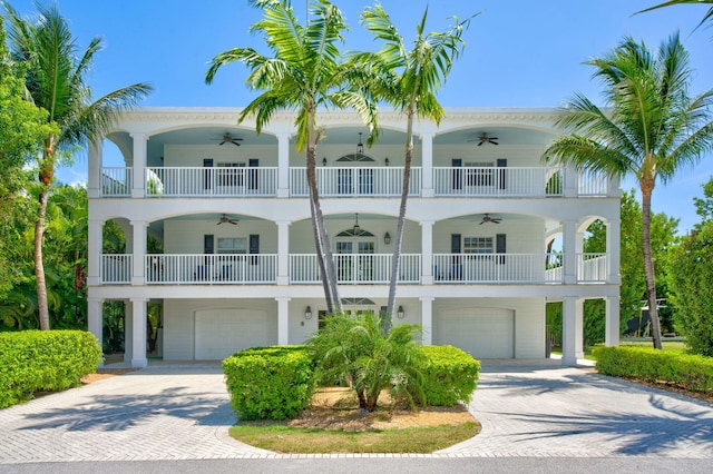 1330 Coury Dr, Key Colony, FL 33051 - raised beach house with a ceiling fan, an attached garage, a balcony, and decorative driveway