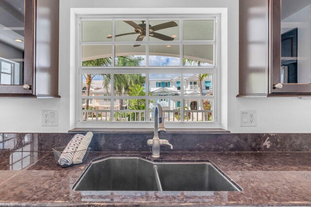 1330 Coury Dr, Key Colony, FL 33051 - kitchen featuring a sink, ceiling fan, glass insert cabinets, dark brown cabinetry, and dark stone counters