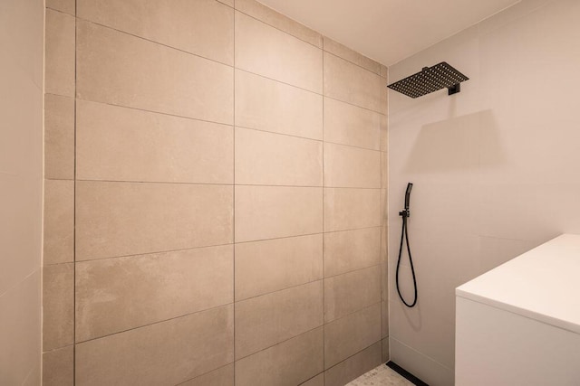 bathroom with tiled shower