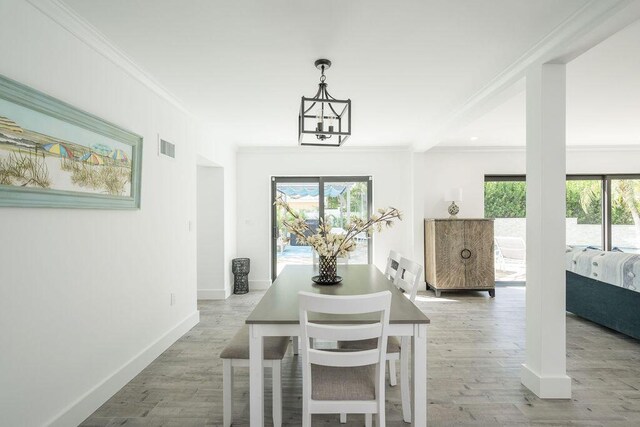 dining area with plenty of natural light, ornamental molding, and wood-type flooring