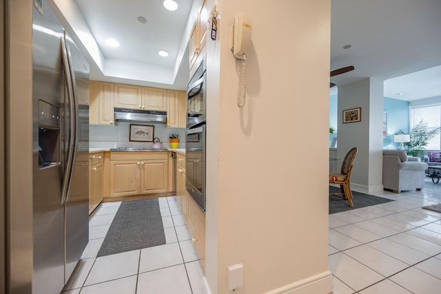115 Front St Unit 202, Key West, FL 33040 - kitchen featuring stainless steel appliances, light tile patterned flooring, a raised ceiling, and light brown cabinetry