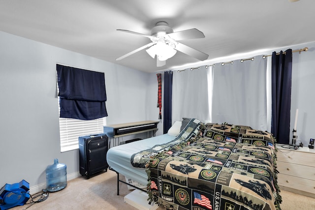 bedroom featuring baseboards, ceiling fan, and carpet