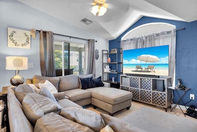 tiled living room featuring visible vents and vaulted ceiling