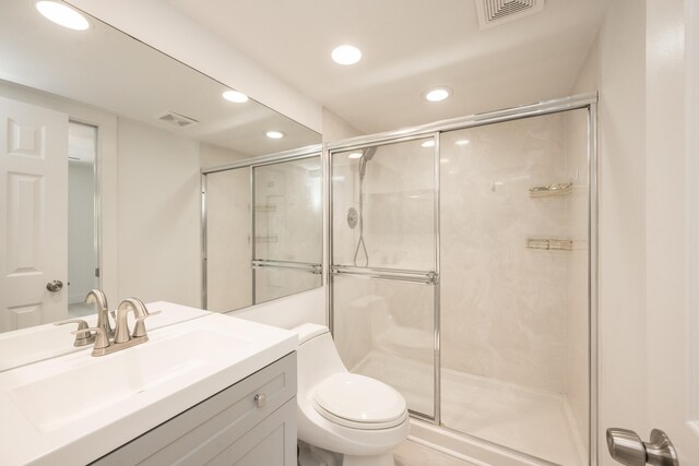 bathroom with vanity, toilet, and walk in shower