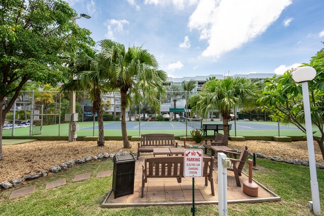 view of home's community with tennis court