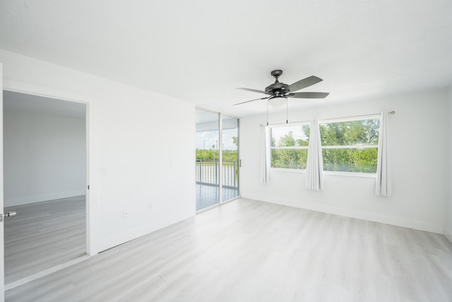 spare room featuring light hardwood / wood-style flooring, plenty of natural light, and ceiling fan