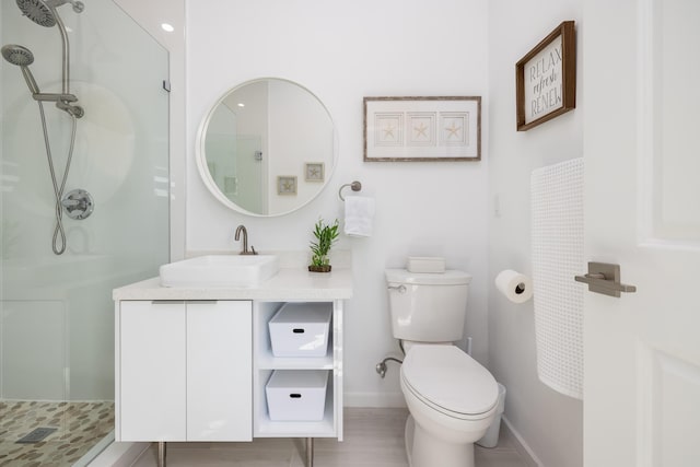 bathroom with vanity, toilet, and walk in shower