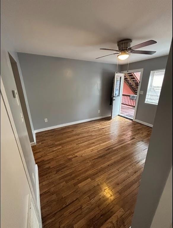 empty room featuring dark hardwood / wood-style flooring and ceiling fan