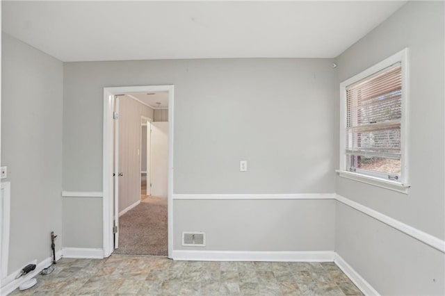 empty room featuring visible vents and baseboards