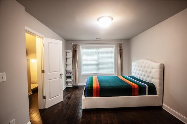 bedroom with dark hardwood / wood-style flooring