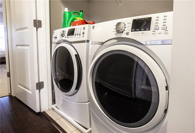 laundry room featuring independent washer and dryer and dark hardwood / wood-style flooring