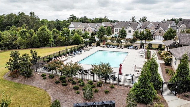 view of swimming pool featuring a patio and a yard