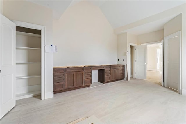 interior space with lofted ceiling and baseboards