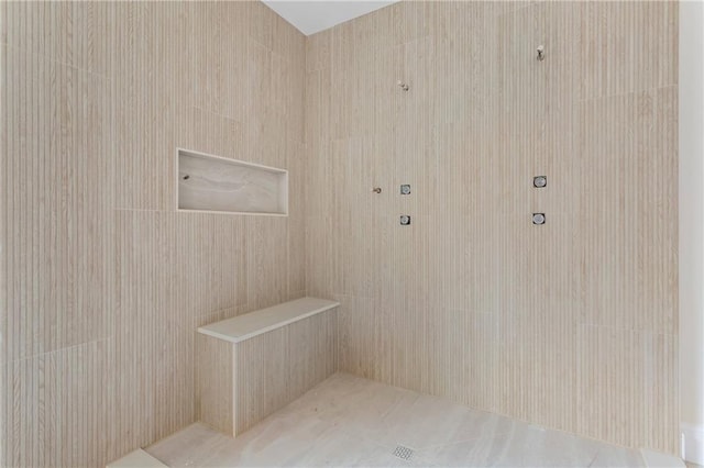 bathroom with a tile shower