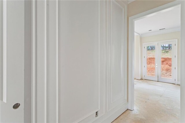 corridor with crown molding and french doors