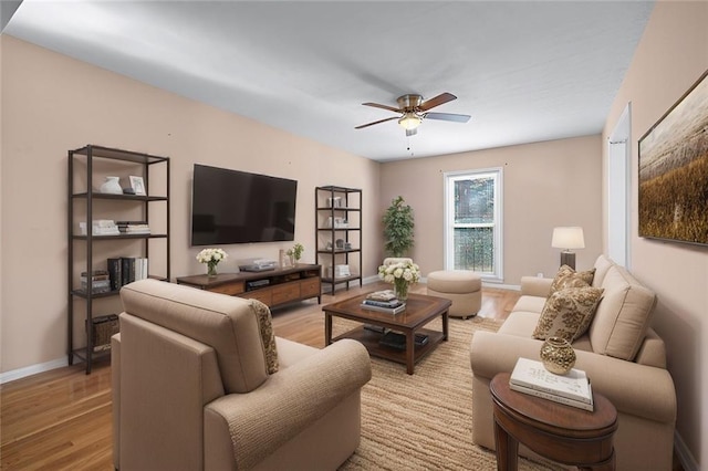 living room featuring ceiling fan and light hardwood / wood-style flooring