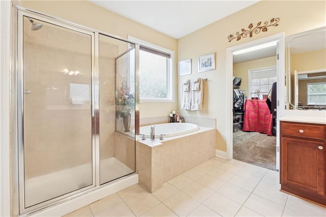 bathroom with a garden tub, tile patterned floors, a healthy amount of sunlight, and a shower stall