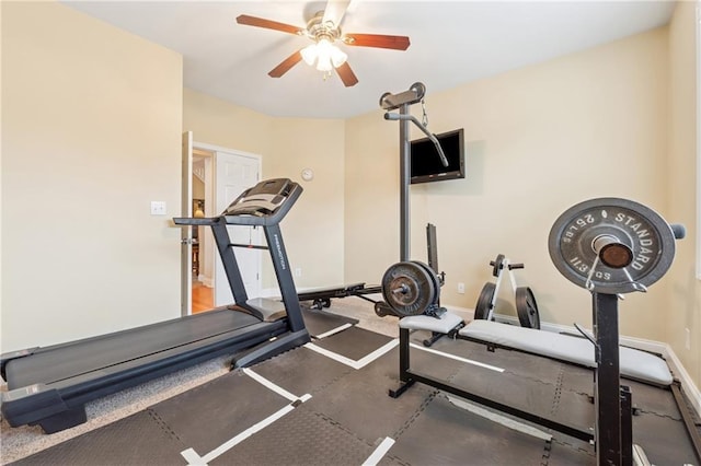 exercise area with ceiling fan and baseboards
