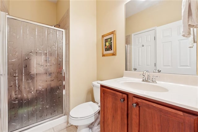 full bathroom featuring vanity, toilet, tile patterned floors, and a stall shower