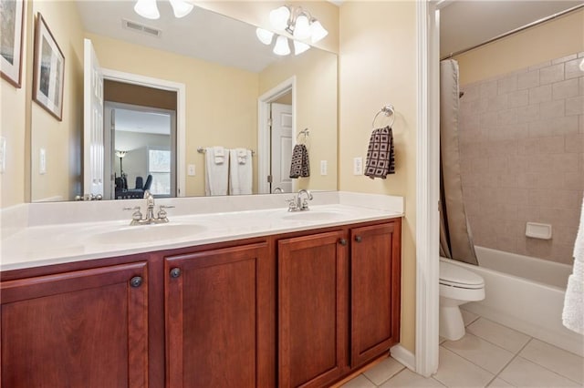 bathroom with double vanity, tile patterned floors, visible vents, and a sink