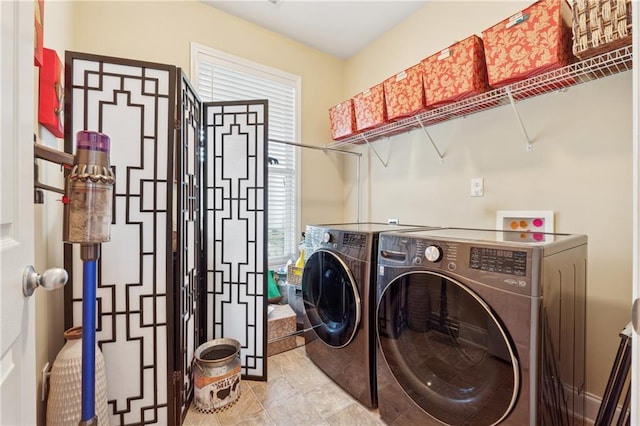 clothes washing area with laundry area, tile patterned floors, and washer and dryer