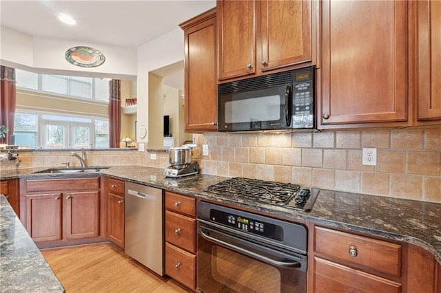 1527 Sage Ridge Dr, Marietta, GA 30064 - kitchen featuring black appliances, a sink, light wood finished floors, and dark stone countertops