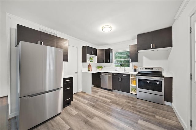 kitchen with appliances with stainless steel finishes, sink, ornamental molding, dark brown cabinetry, and light hardwood / wood-style floors