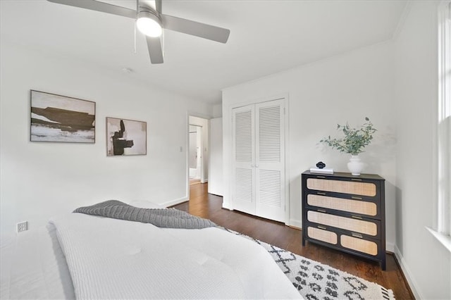 bedroom with ceiling fan, dark hardwood / wood-style floors, and a closet