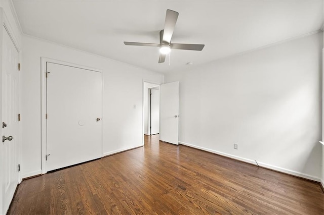 unfurnished bedroom featuring ceiling fan and dark hardwood / wood-style flooring