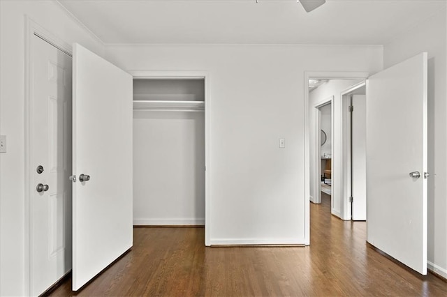 unfurnished bedroom with a closet and dark hardwood / wood-style floors