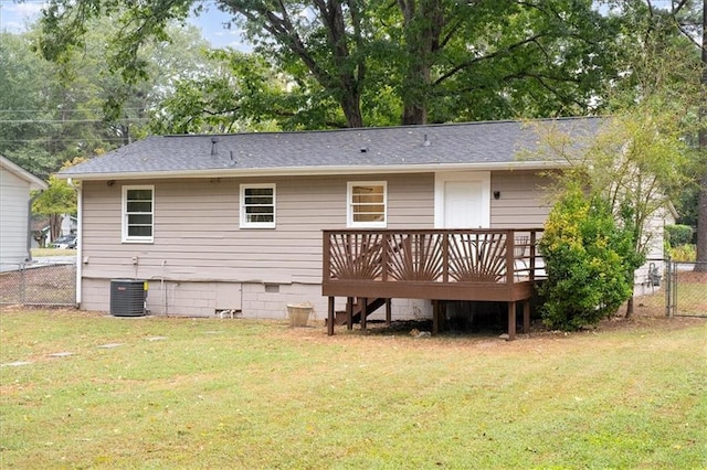 back of house with a wooden deck, central AC unit, and a lawn