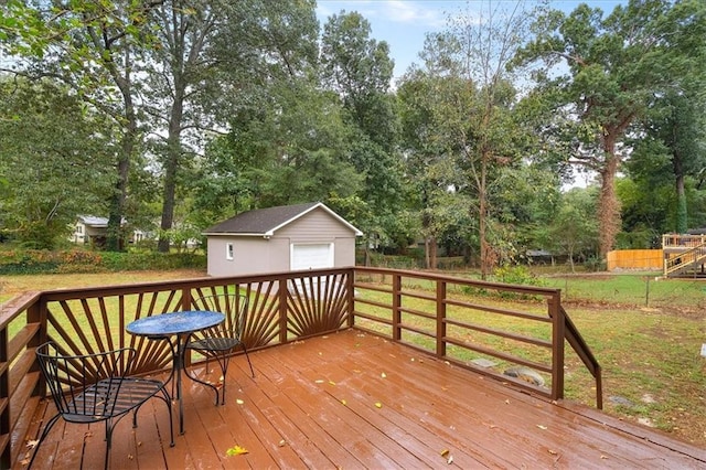 deck featuring a yard, an outdoor structure, and a garage