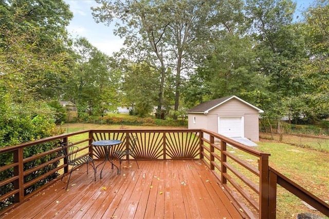 wooden terrace with a garage, an outdoor structure, and a yard