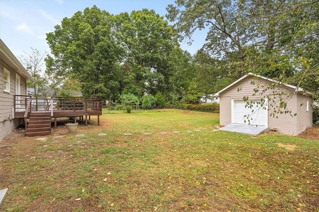 view of yard featuring a garage, an outdoor structure, and a deck