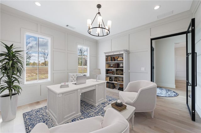 office area with an inviting chandelier, crown molding, and light hardwood / wood-style floors