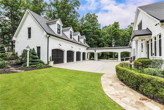 15595 Birmingham Hwy, Alpharetta, GA 30004 - view of side of home featuring a lawn, concrete driveway, an attached garage, and brick siding