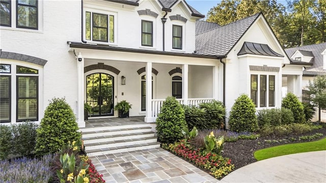 15595 Birmingham Hwy, Alpharetta, GA 30004 - view of front of property with a porch, a standing seam roof, stucco siding, and a metal roof
