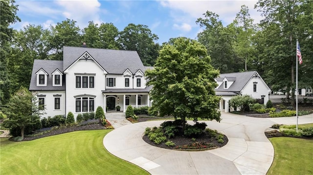 15595 Birmingham Hwy, Alpharetta, GA 30004 - view of front facade with curved driveway, a porch, and a front yard